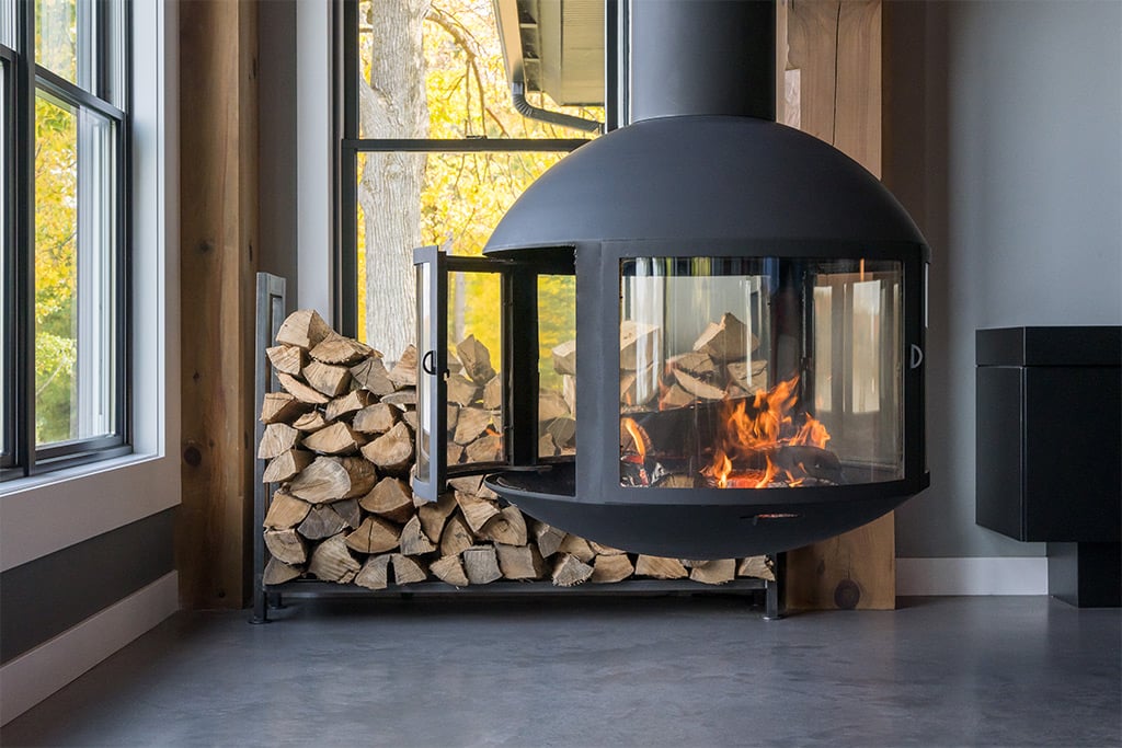 Suspended wood burning fireplace in living room